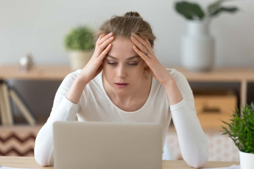 woman student looking at laptop yoga